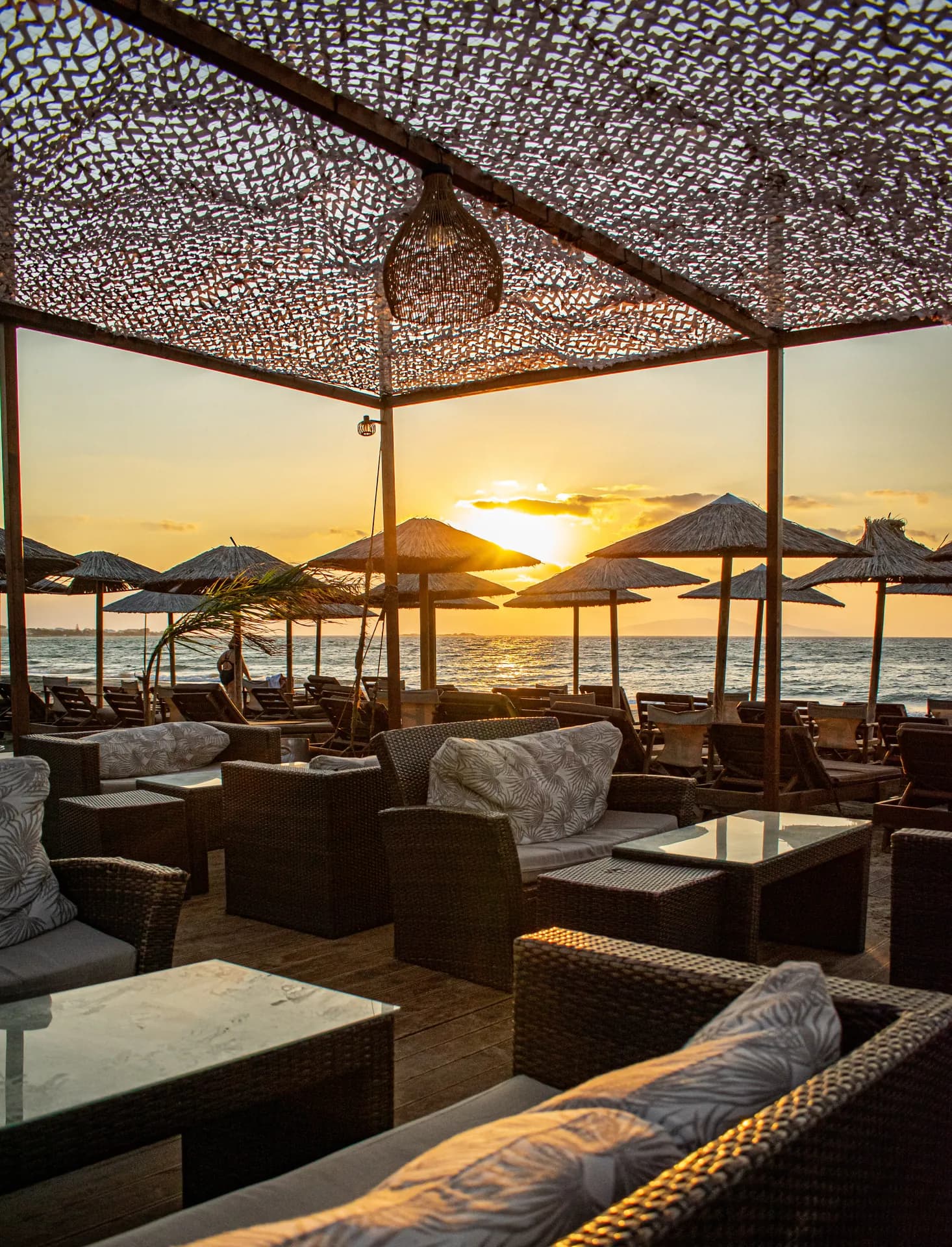 Σαλόνι lounge κάτω από σκίαση με θέα στο ηλιοβασίλεμα